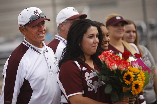 Cimarron-Memorial softball coach Steve Gorden, left, stands behind his players during a cere ...