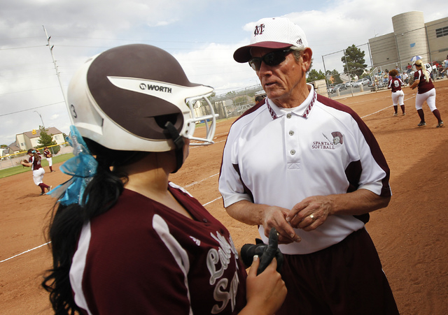 Cimarron-Memorial softball coach Steve Gorden offers some advice to Alexa Snyder (13) during ...