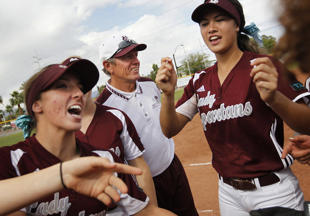 Cimarron-Memorial softball coach Steve Gorden, middle, joins in with his players before thei ...