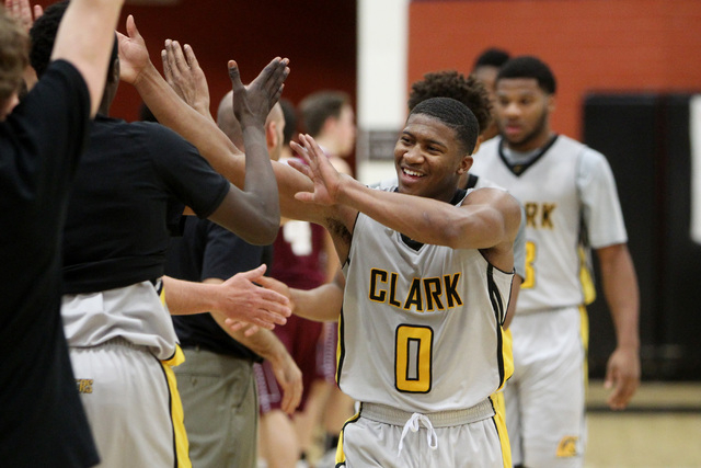 Clark guard Colby Jackson celebrates with teammates after defeating Faith Lutheran 64-49 Thu ...