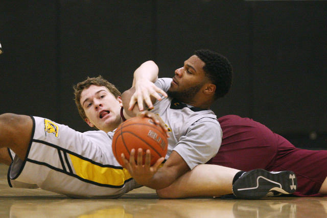 Clark forward Ty’Rek Wells keeps a loose ball away from Faith Lutheran forward Zach Fr ...