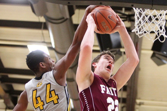 Clark forward Darius Jackson blocks a shot by Faith Lutheran forward Zach Friel during their ...
