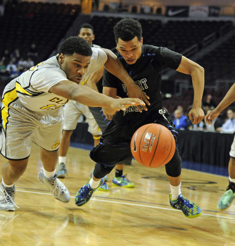 Clark forward Ty’Rek Wells, left, and Desert Pines guard Coby Myles dive for a loose b ...