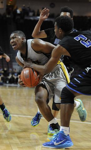 Clark guard Colby Jackson makes a layup despite being fouled by Desert Pines guard Jordan Si ...