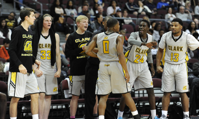 Clark guard Colby Jackson high fives the bench after making a layup despite being fouled by ...