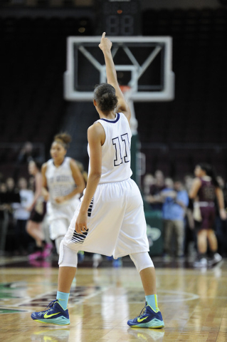 Spring Valley guard Kayla Harris (11) signals points after assisting on a fast-break basket ...