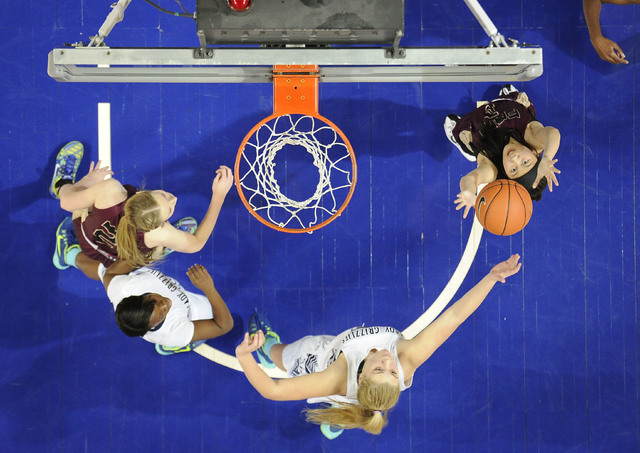 Faith Lutheran guard Madison Bocobo, left, pulls down a Spring Valley rebound in front of gu ...