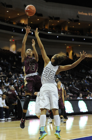 Faith Lutheran guard Haley Vinson (12) makes a field goal attempt as Spring Valley Lynnae Wi ...