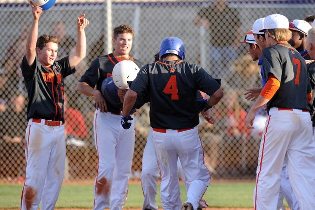 Bishop Gorman players swarm home plate after Brandon Wulff (4) hit a walk-off grand slam in ...