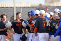 Bishop Gorman players swarm home plate after Brandon Wulff (blue helmet) hit a walk-off gran ...