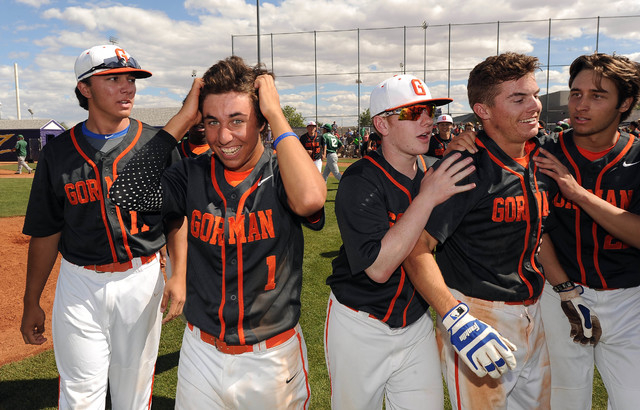 Bishop Gorman players celebrate with Cadyn Grenier, right, blue batting gloves, after he hit ...