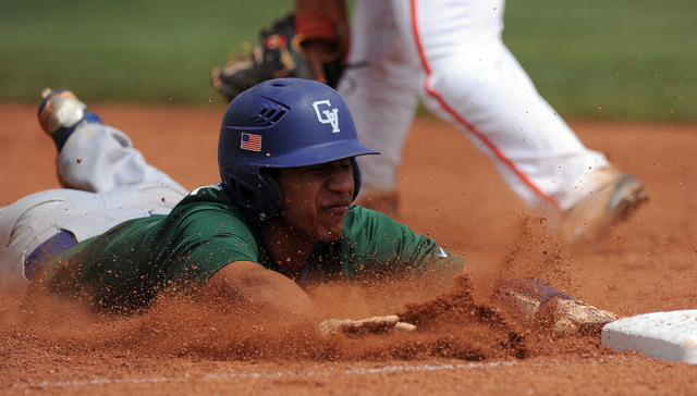 Green Valley base runner Jimmy Montiel slides into third base after advancing on a Bishop Go ...