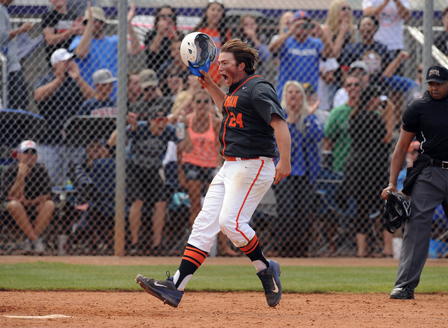 Bishop Gorman first baseman Austin Cram (24) crosses home plate after hitting the tying two- ...