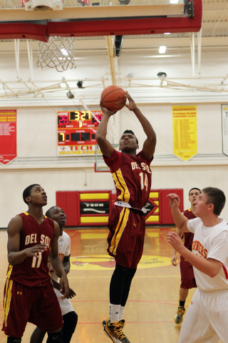 Del Sol forward Brian Greer (14) goes up for a shot past Southeast Career Tech’s Sean ...