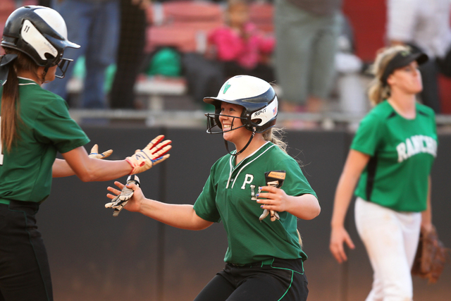 Palo Verde’s Lo Oxford (10), right, opens her arms as she scores the winning run to em ...