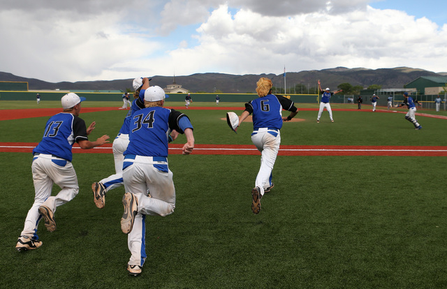 The Basic Wolves celebrate their 9-1 win over Centennial for the NIAA DI baseball championsh ...