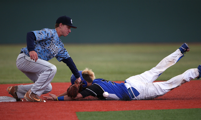 Basic’s Roger Riley steals second against Centennial’s Kian Wilbur in the NIAA ...