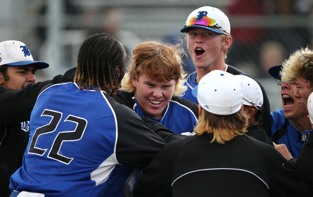 Basic’s Jack Wold is greeted by teammates after hitting a three-run home run against ...