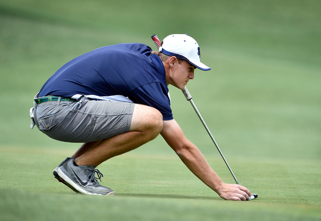Shadow Ridge’s Tanner Johnson sets his ball on the first green during the first round ...