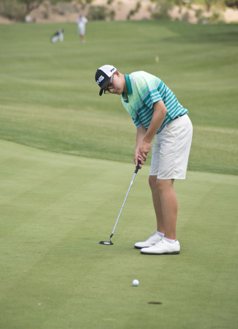 Bishop Manogue’s Ollie Osborne putts during the Division I state boys golf tournament ...