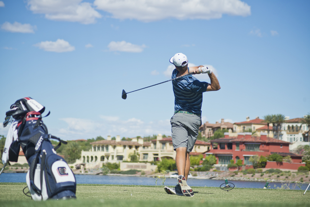 Shadow Ridge’s Tanner Johnson hits his ball during the Division I state boys golf tour ...
