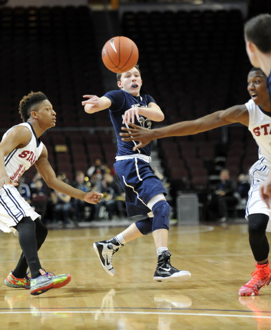 The Meadows School guard Ethan Fridman passes as Agassi Prep guard Deishaun Booker, left, an ...