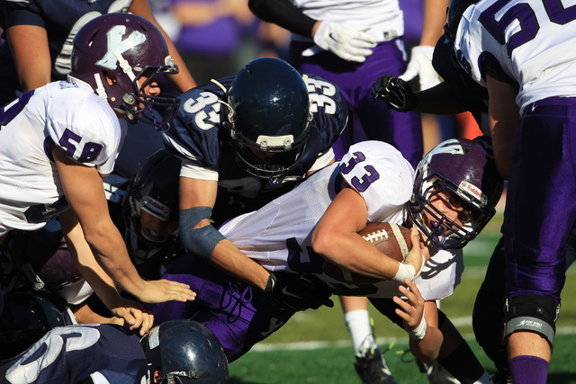 Yerington running back Harrison Cisneros stretches for extra yardage against The Meadows dur ...