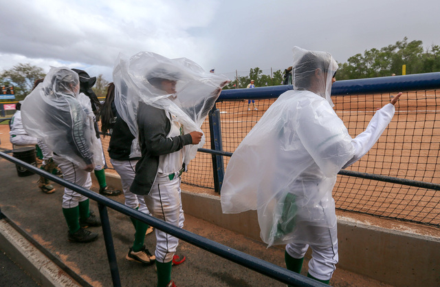 The Rancho Rams bench fights rain and wind during a NIAA DI softball game against Reed at UN ...