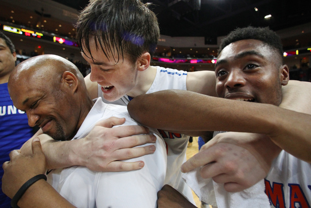 Bishop Gorman’s Stephen Zimmerman hugs assistant coach Mike Wright and teammate Ugo Am ...