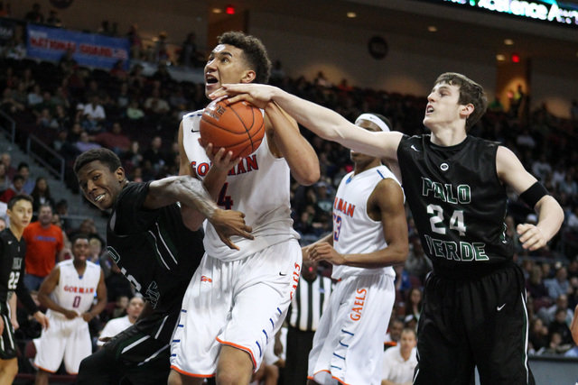 Bishop Gorman center Chase Jeter is defended by Palo Verde forward Jamell Garcia-Williams wh ...