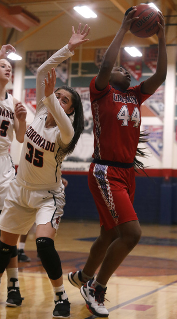Liberty junior Dre’una Edwards (44) grabs a rebound during a basketball game on Tuesda ...