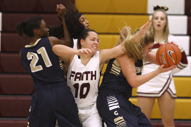 Spring Valley forward Jessica Rafay grabs a rebound away from Faith Lutheran guard Kim Munro ...