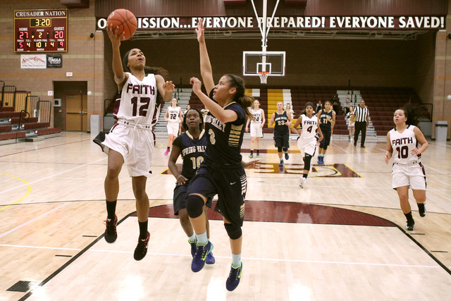 Faith Lutheran guard Haley Vinson is defended by Spring Valley guard Bria Hardin-Davidson on ...