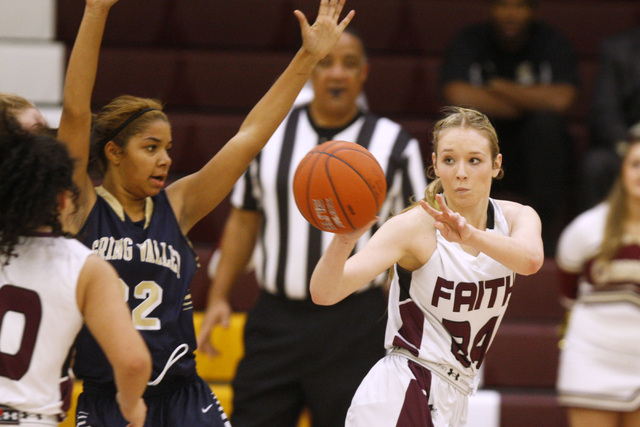 Faith Lutheran forward Morgan Hill passes the ball while being defended by Spring Valley for ...
