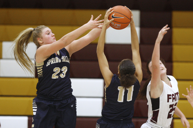 Spring Valley forward Jessica Rafay, left, and guard Kayla Harris battle for a rebound with ...