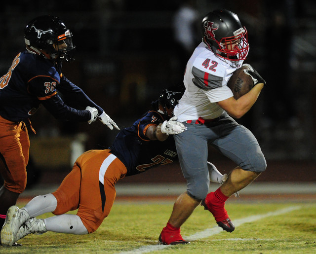 Arbor View fullback Andrew Wagner (42) breaks the tackle of Legacy safety Jordan Wilson whil ...