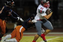 Arbor View fullback Andrew Wagner (42) breaks the tackle of Legacy safety Jordan Wilson whil ...