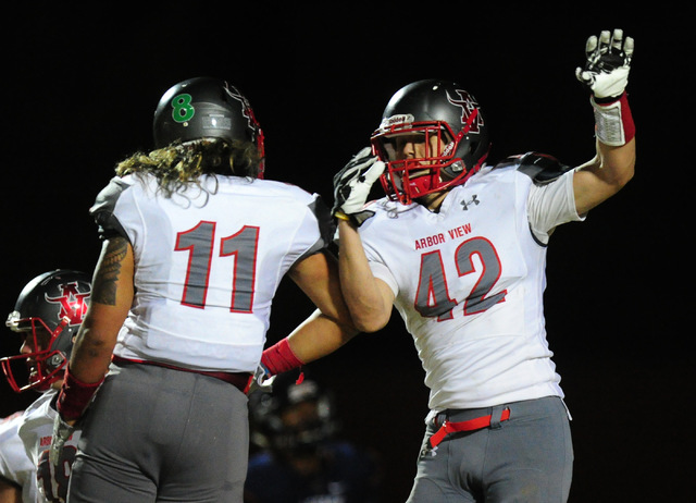 Arbor View fullback Andrew Wagner (42) is congratulated by Zach Melson after Wagner scored a ...