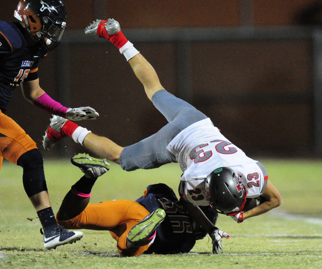 Arbor View running back Deago Stubbs (23) is upended after being tackled by Legacy safety Am ...