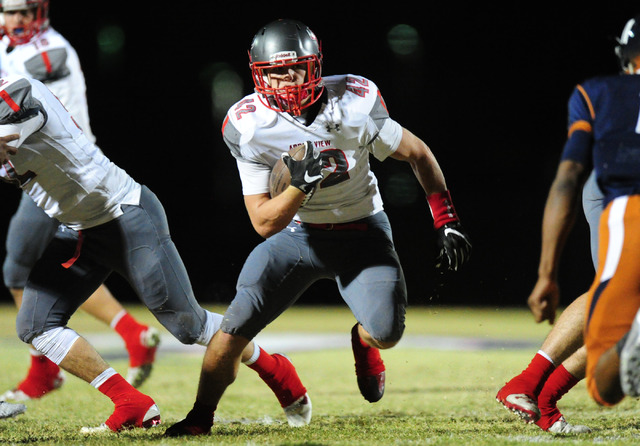 Arbor View fullback Andrew Wagner runs through a hole against Legacy in the first half of th ...