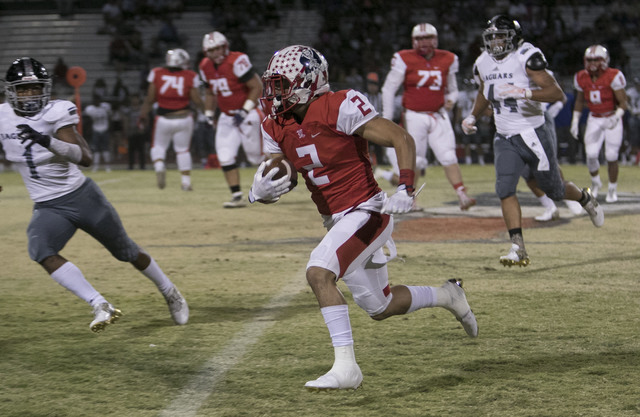 Liberty’s Ethan Dedeaux (2) runs for a gain against Desert Pines during a varsity foot ...