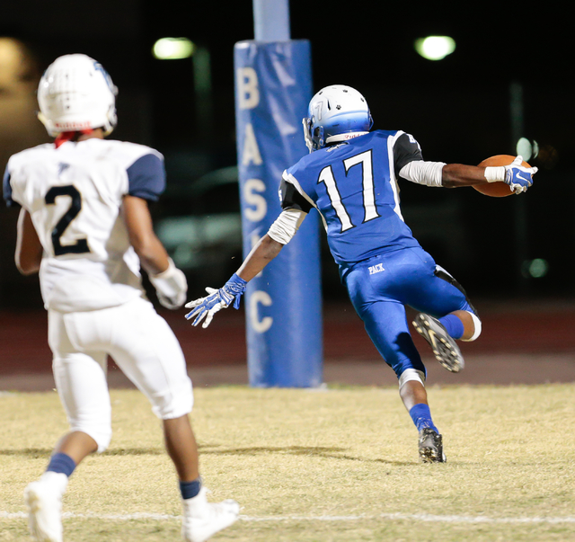 Basic senior Quison Owens (17) raises his arms with the ball as he runs the ball in for a to ...