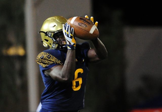 St. Thomas Aguinas, Fla. wide receiver Jonathan Moore catches a pass against Bishop Gorman i ...