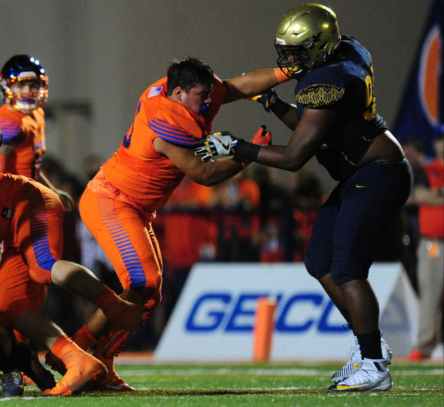 Bishop Gorman guard center Adrian Dupuis, left, battles St. Thomas Aguinas, Fla. linebacker ...