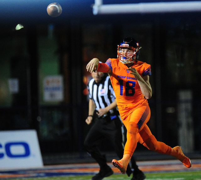Bishop Gorman quarterback Tate Martell passes while on the run against St. Thomas Aguinas, F ...