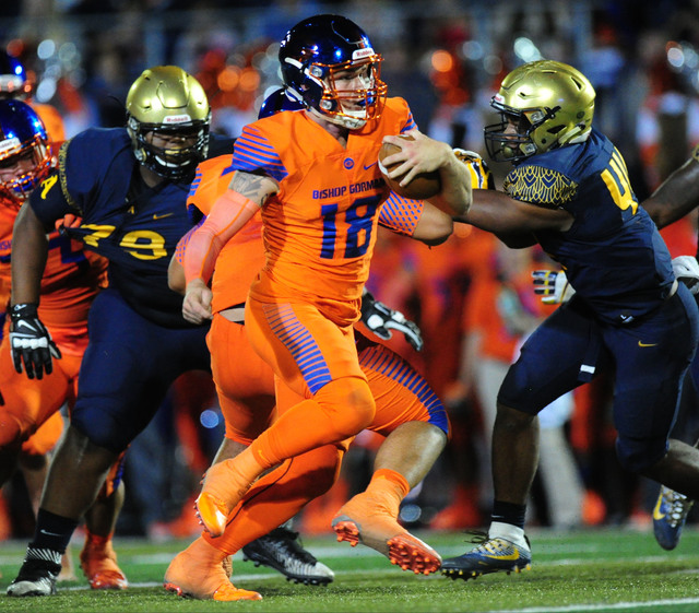 Bishop Gorman quarterback Tate Martell rushes for a first down against St. Thomas Aguinas, F ...