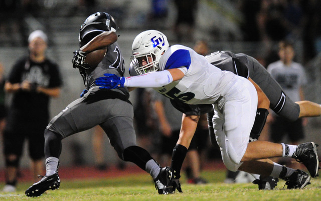 Green Valley linebacker Brock Hershberger tackles Palo Verde running back Terrill Jimerson ...