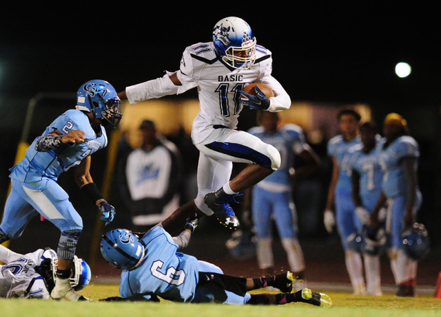 Basic High School wide receiver Harris Frank (11) jumps over Canyon Springs cornerback Joshu ...