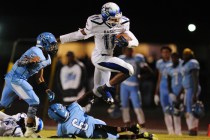 Basic High School wide receiver Harris Frank (11) jumps over Canyon Springs cornerback Joshu ...
