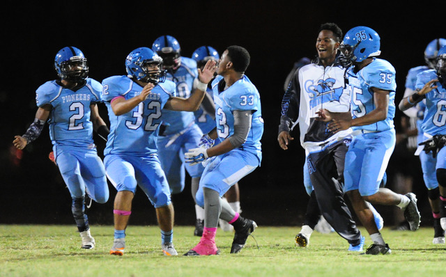 Canyon Springs players celebrate after kicker Cesar Barron-Rodriguez (32) kicked the game wi ...